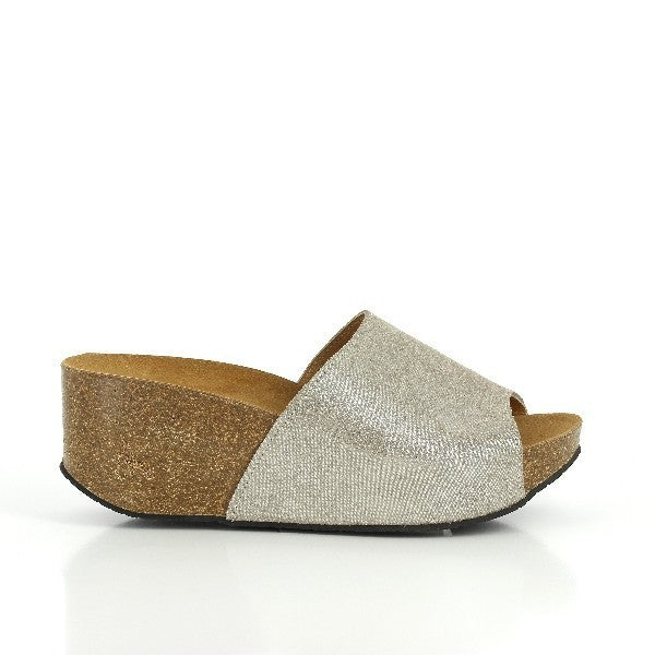A chic photo showcasing Plakton's 273112 Grey Glitter Wedges from their Women's Collection. Handcrafted in Spain, these wedges feature a premium leather upper with glitter detail, an adjustable ankle strap, and a comfortable cork sole. Perfect for adding a touch of sparkle and elegance to any casual outfit.